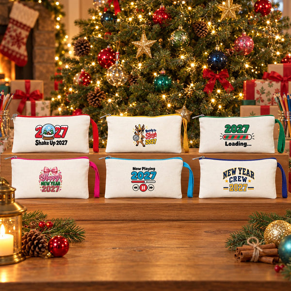 Six cream Christmas pencil cases with red, yellow, green, pink, turquoise and navy zippers standing on a wooden riser in front of a decorated Christmas tree, with gifts and jars of coloured pencils