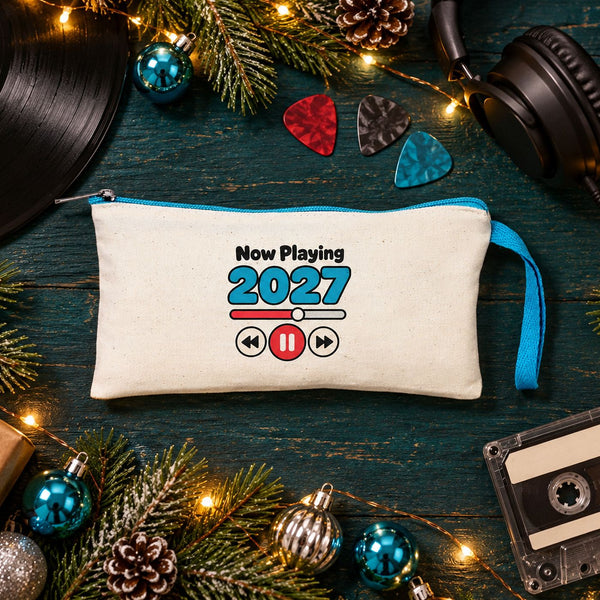 Cream pencil pouch with a turquoise zipper and a Now Playing 2027 music player print with a vinyl record, headphones and a cassette tape