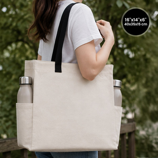 Blank canvas tote bag 16"W x 14"H x 6"L in natural cotton with black woven handles and side pockets