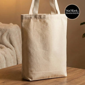 Beige tote bag on a wooden surface with dimensions displayed