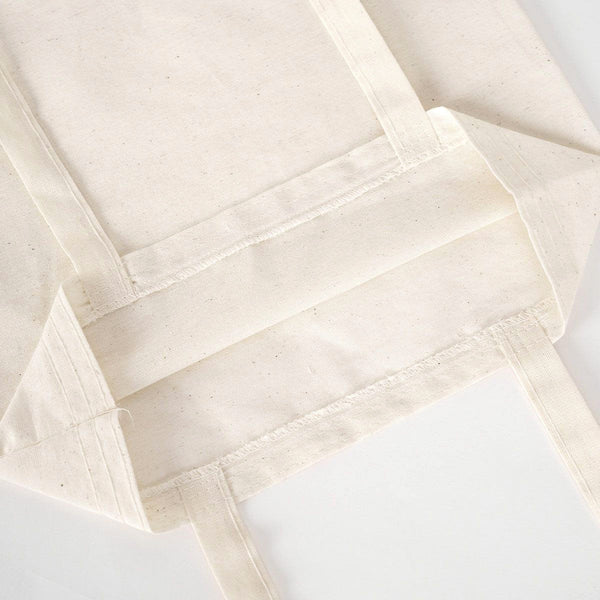Close-up of beige fabric with a textured pattern on a white background