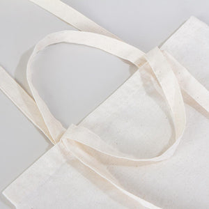 White tote bag with a handle on a light gray background