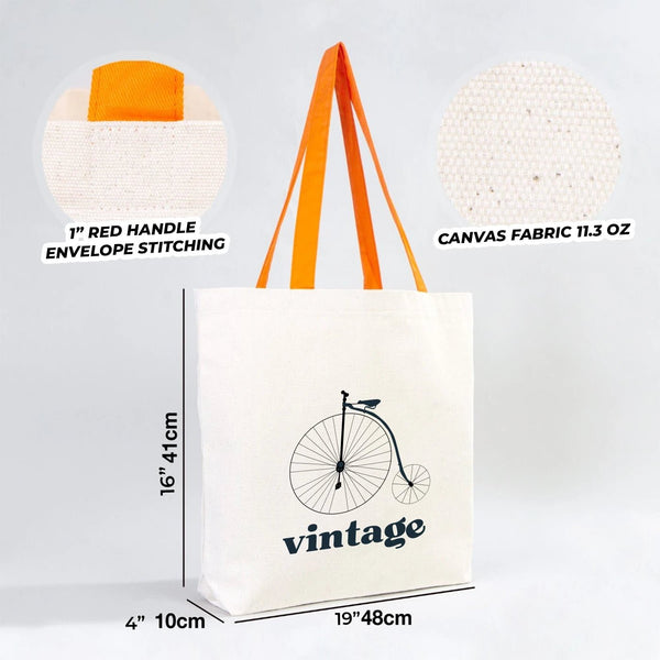 Canvas tote bag with orange handles, vintage bicycle design, and measurements on a light gray background