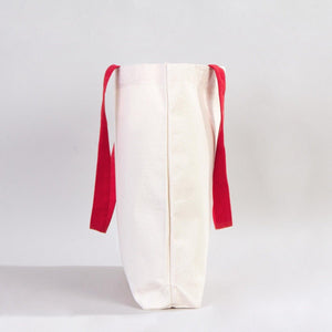 White bag with red straps on a light gray background