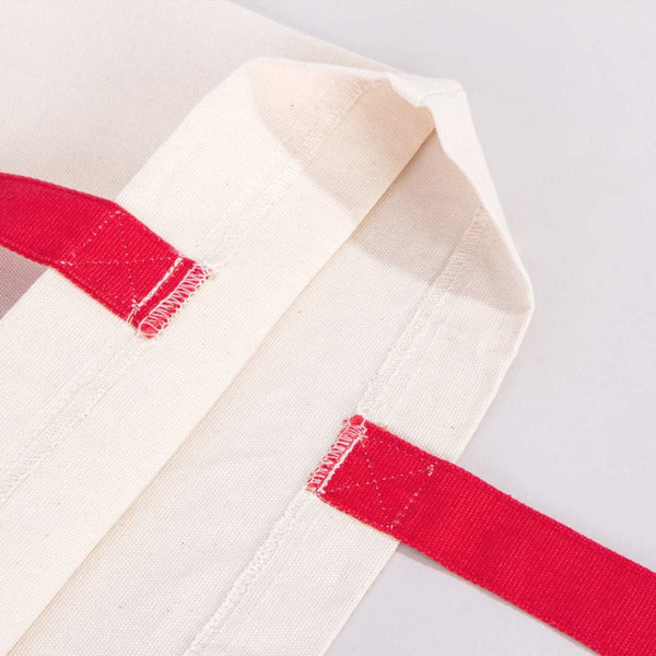 White martial arts gi with red belt on a light gray background