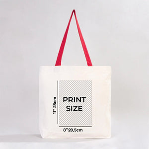 White tote bag with red handles and print size measurement text on a light gray background