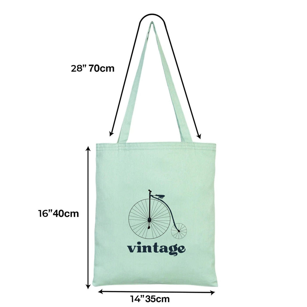 Green tote bag with customizable text area on a neutral background