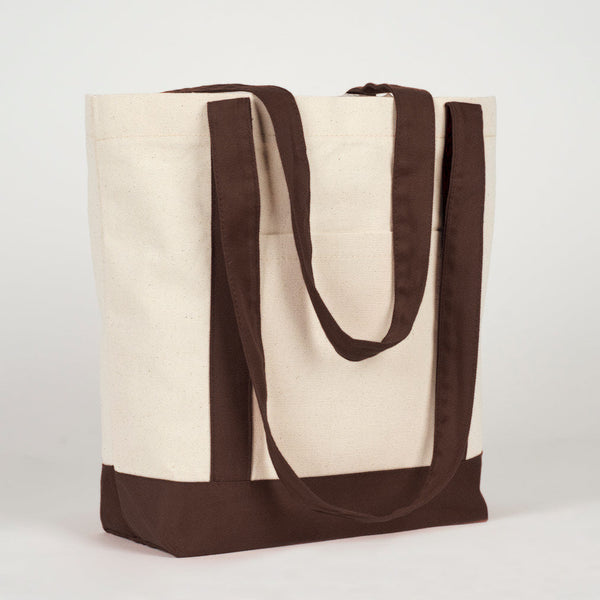 Three-quarter view of the canvas tote with dark brown handles - Pamusan.com