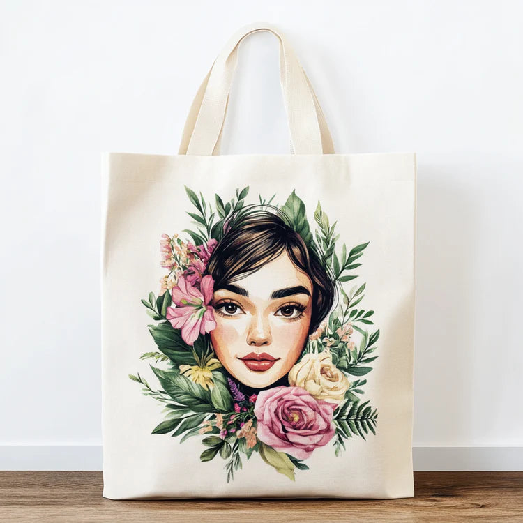 Tote bag with a floral and portrait design on a white background
